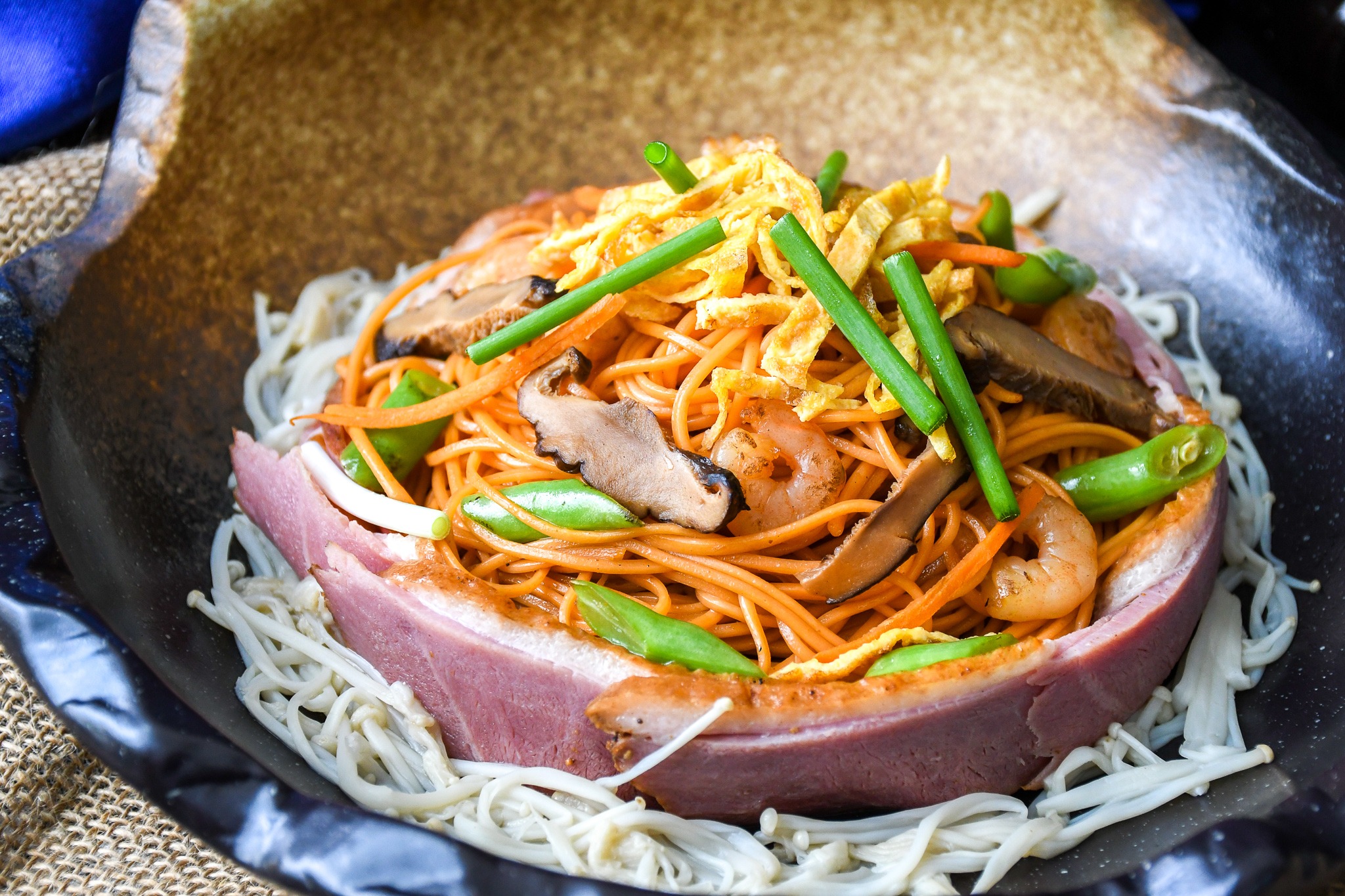 stir fried longevity noodles with smoked duck and golden needle enoki mushrooms